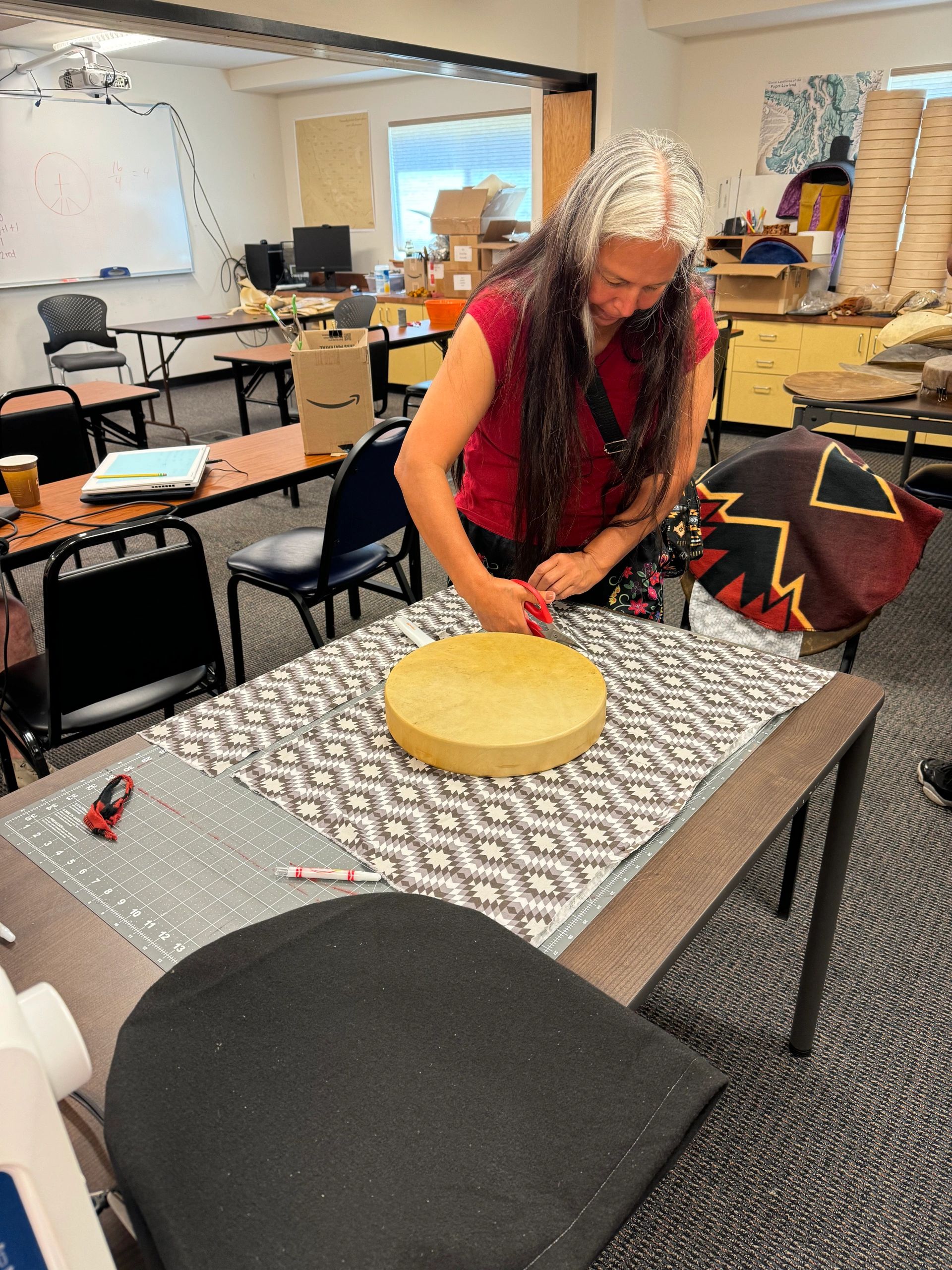 Working on a hand drum in a community workshop